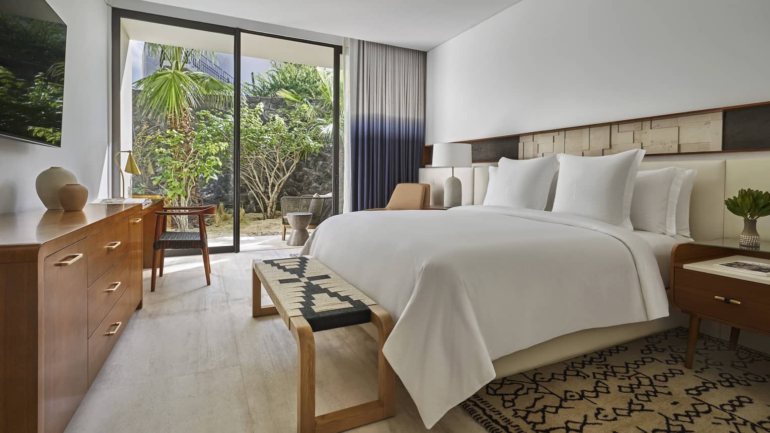 Bedroom, king bed, wooden dresser, walk-out patio with trees