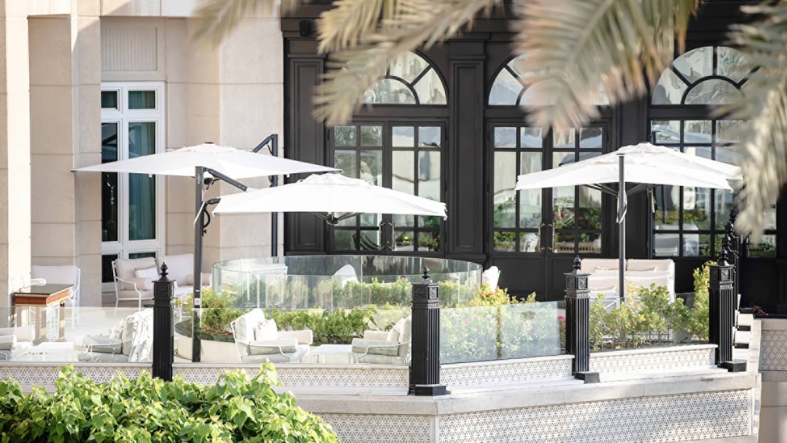 Seasons Tea Lounge patio lounge sofas under white umbrellas