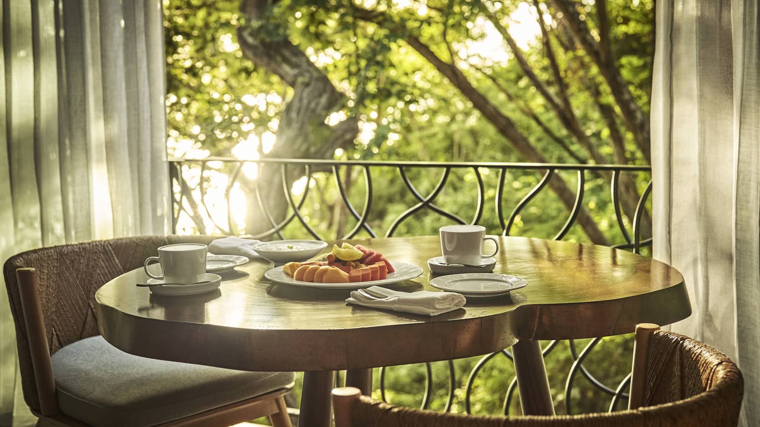 Natural wood table by the window, set for breakfast