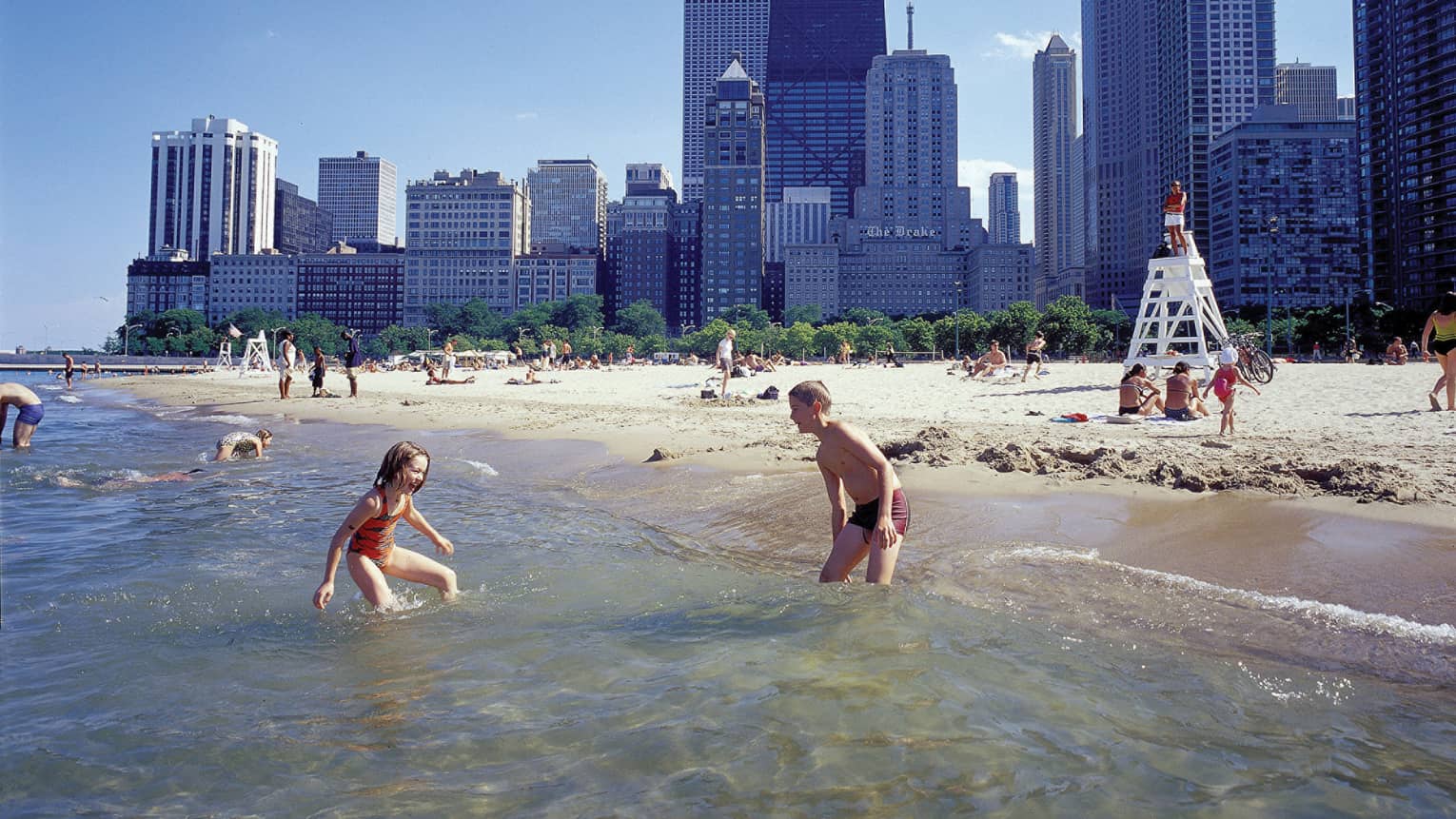 Young children playing on a beach.