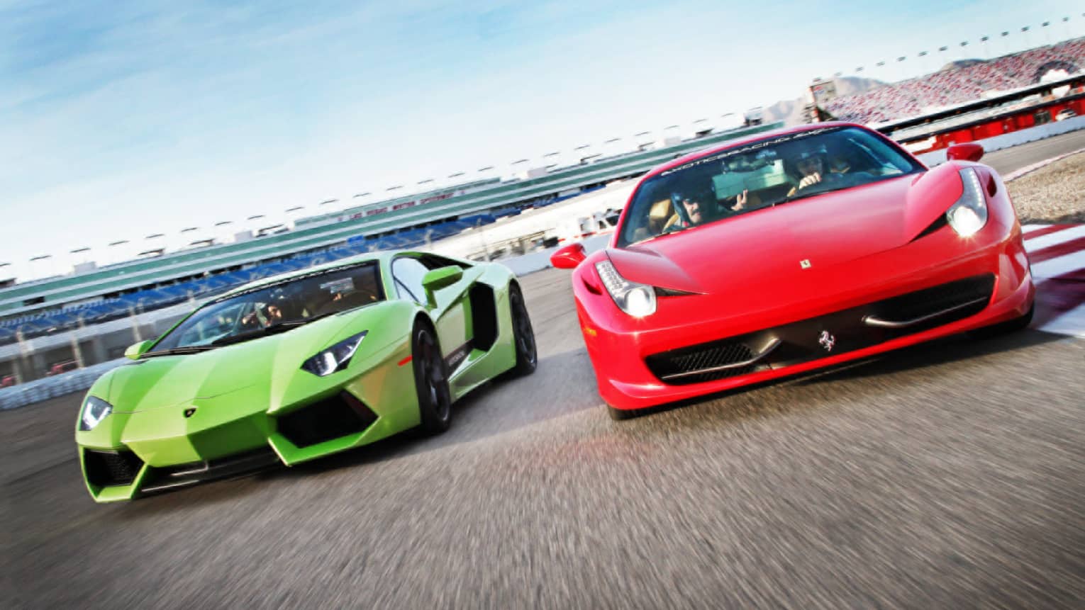 Red and green sports cars on race track