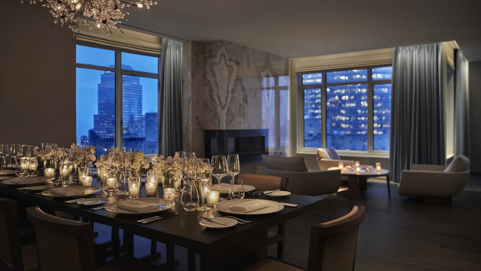 Royal Suite event set up, dining table with glowing candles near seating area