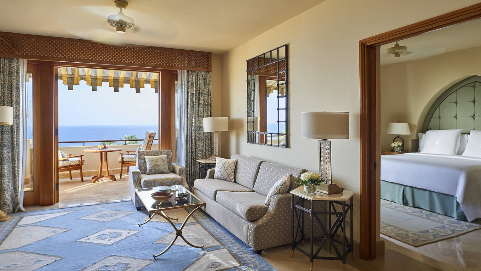 One bedroom suite seating are between large open doors to patio, bedroom