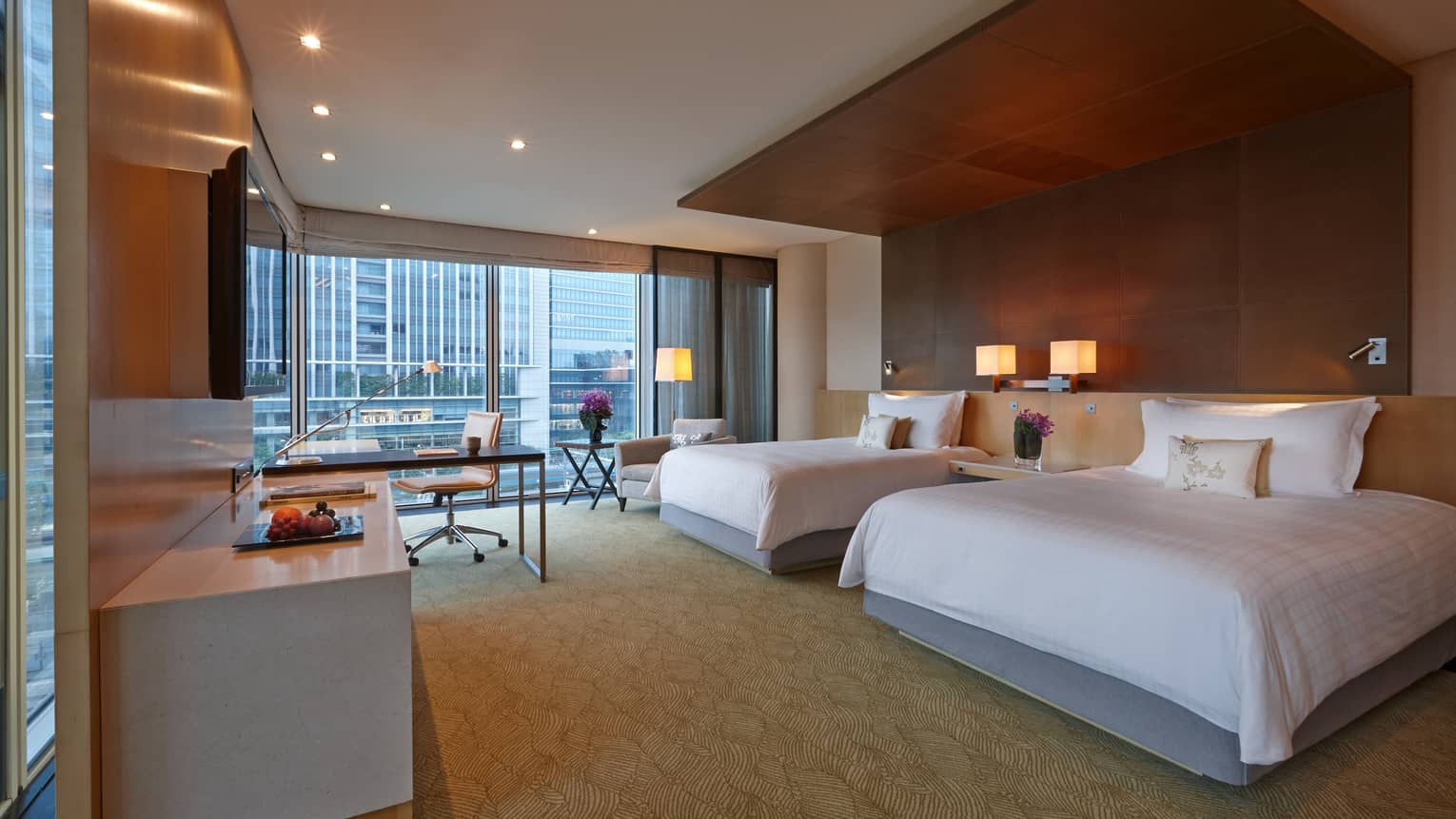 Deluxe Premier Room double beds across from dresser, TV, desk by large window