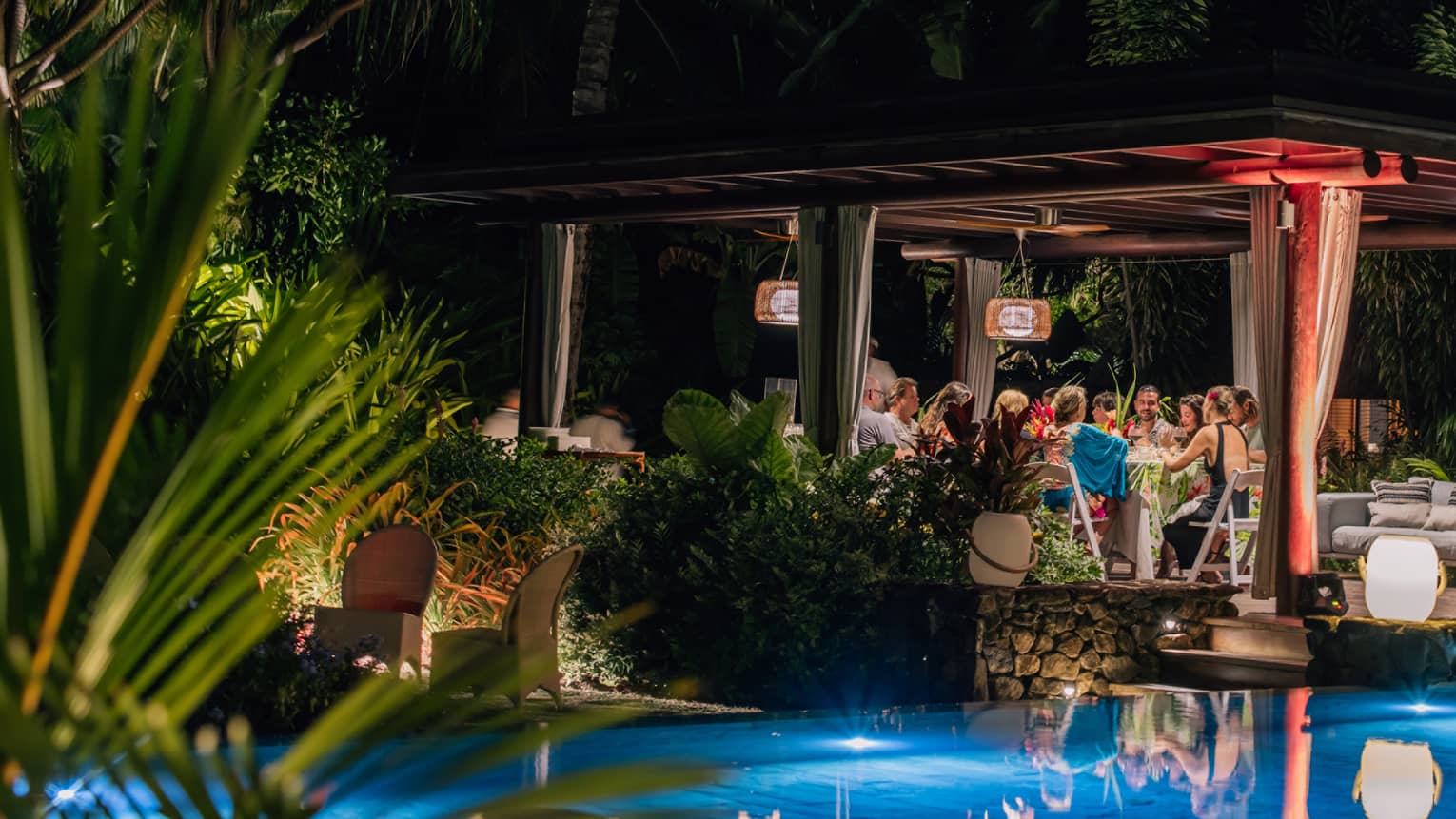 Dinner party at night by the pool at Four Seasons Resort Bora Bora