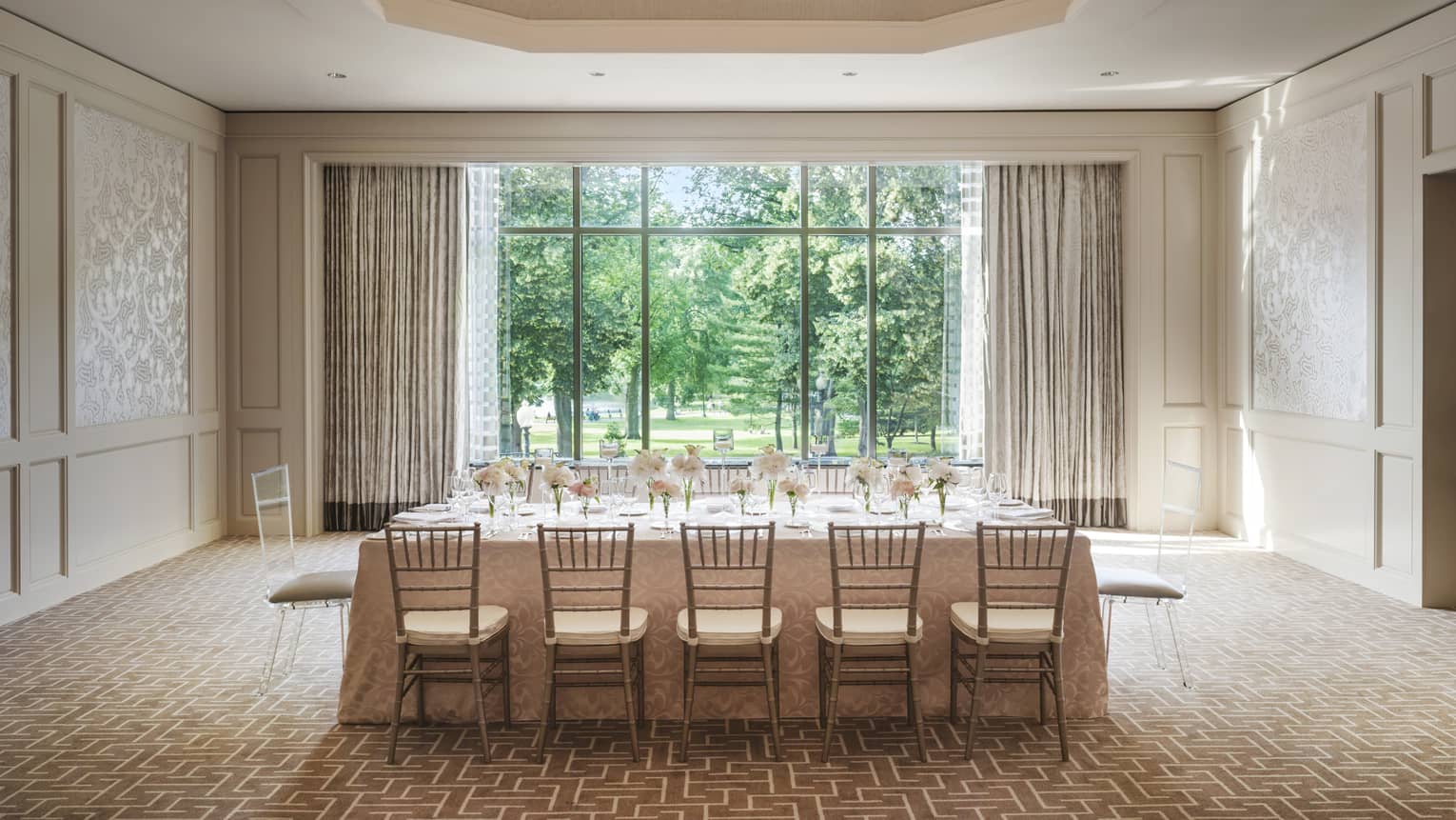 Private dining table with flowers under dome ceiling with crystal chandelier, by sunny window