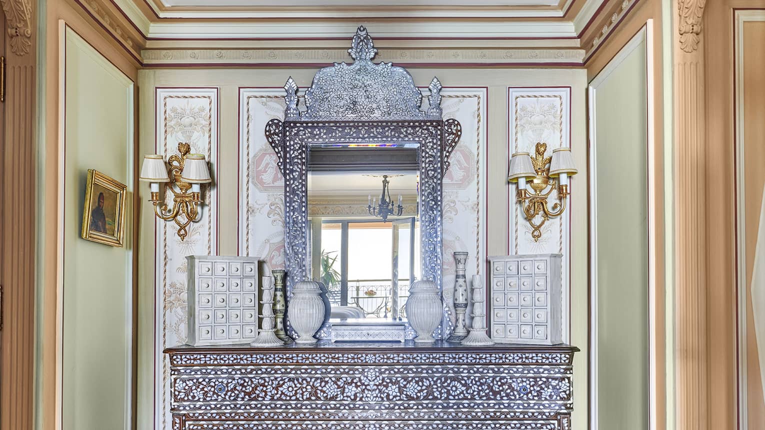 Royal Suite entryway with intricate sideboard, rug and crystal chandelier