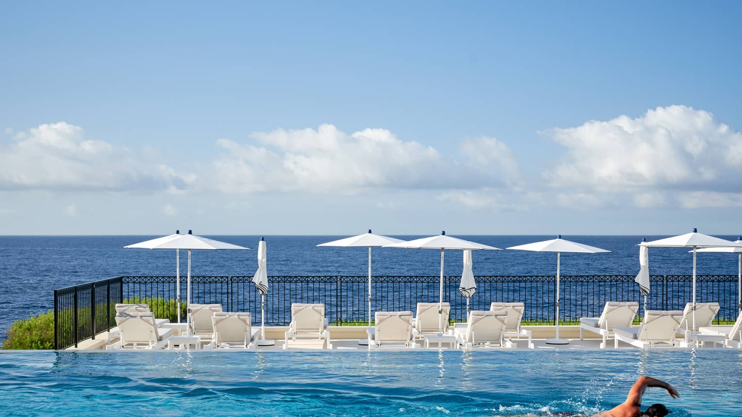 Man swimming in infinity pool