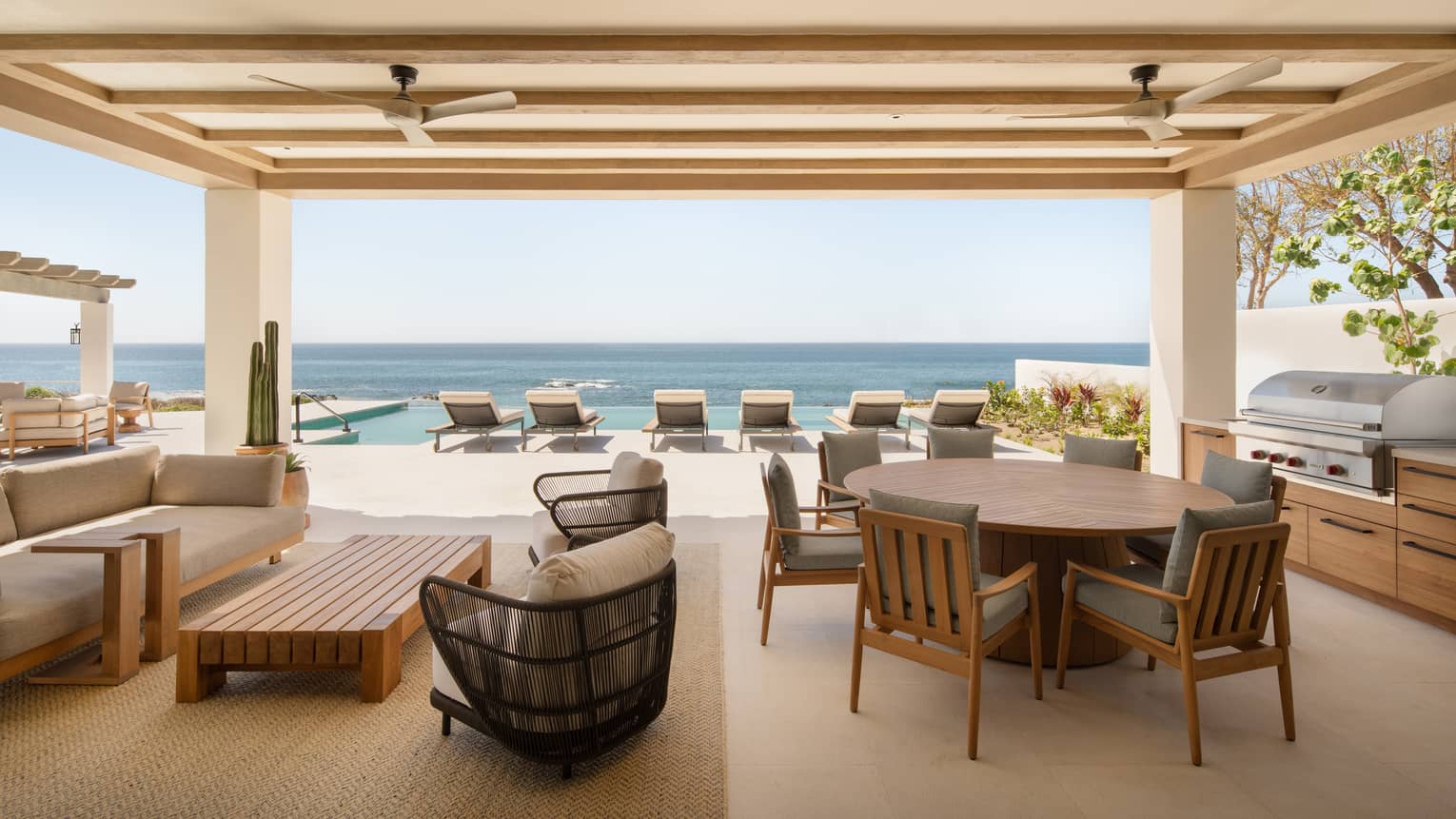 Luxury oceanfront suite terrace with dining, lounge and pool furniture, at Four Seasons Resort Cabo San Lucas at Cabo Del Sol