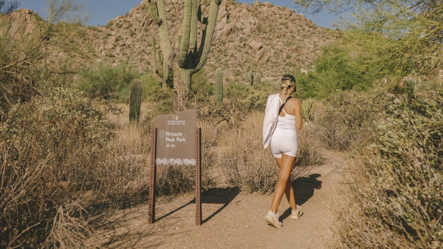 A guest wearing exercise clothes and going on a hike in the desert