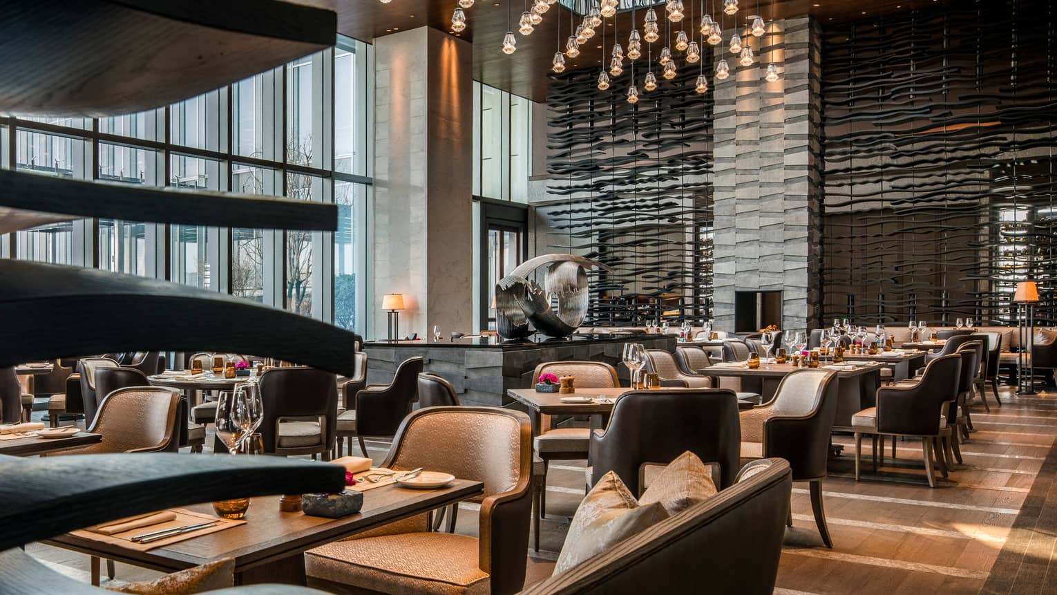 Cielo dining room, tables and chairs, modern silver sculpture, accent wall