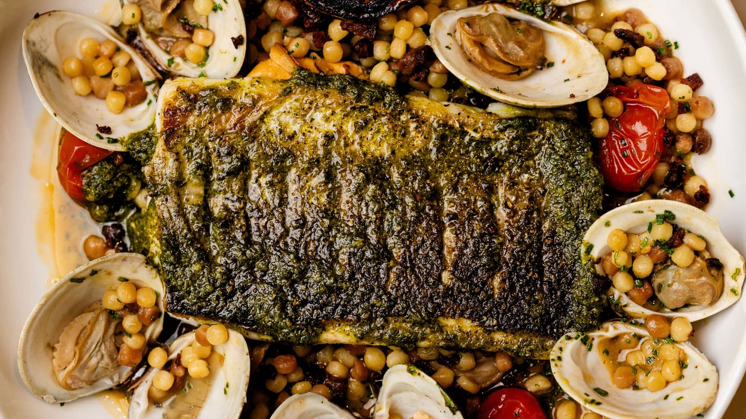 Roasted branzino with clams and seasoning
