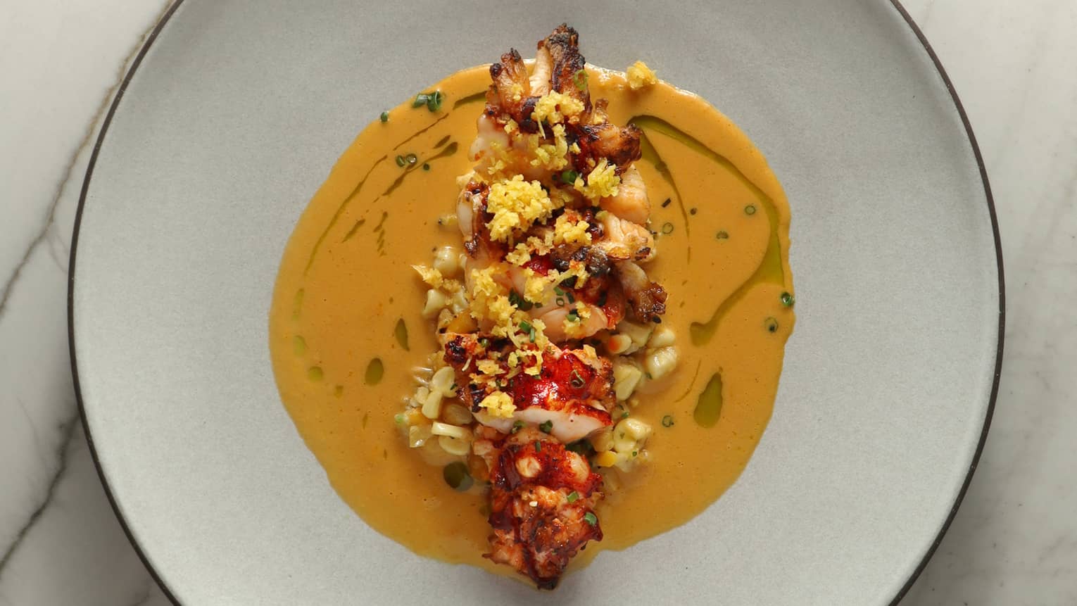 Lobster in an orange coloured sauce.