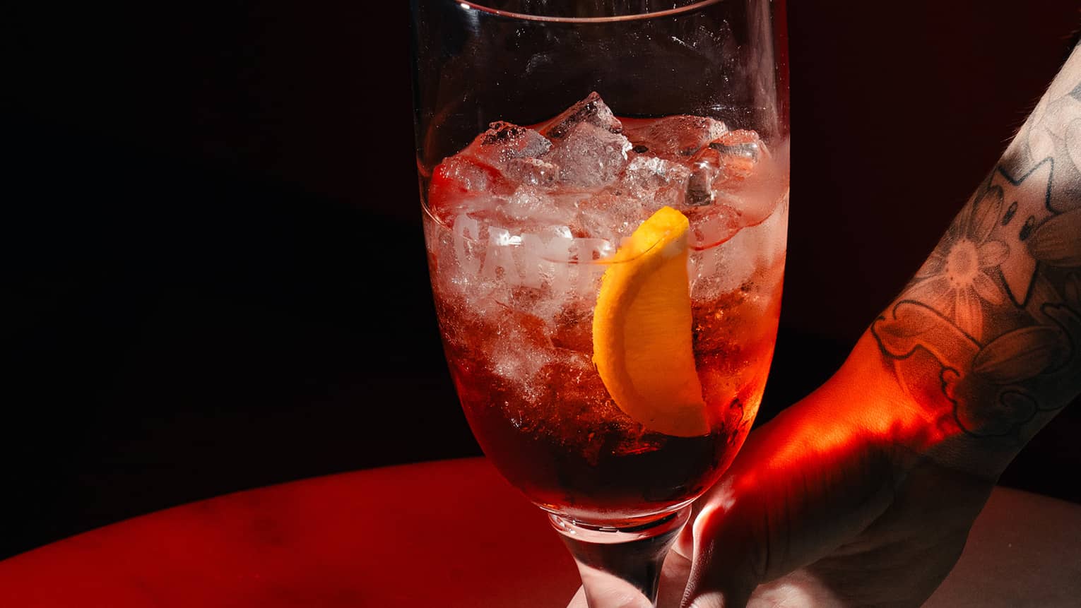 Sbagliato cocktail garnished with an orange slice