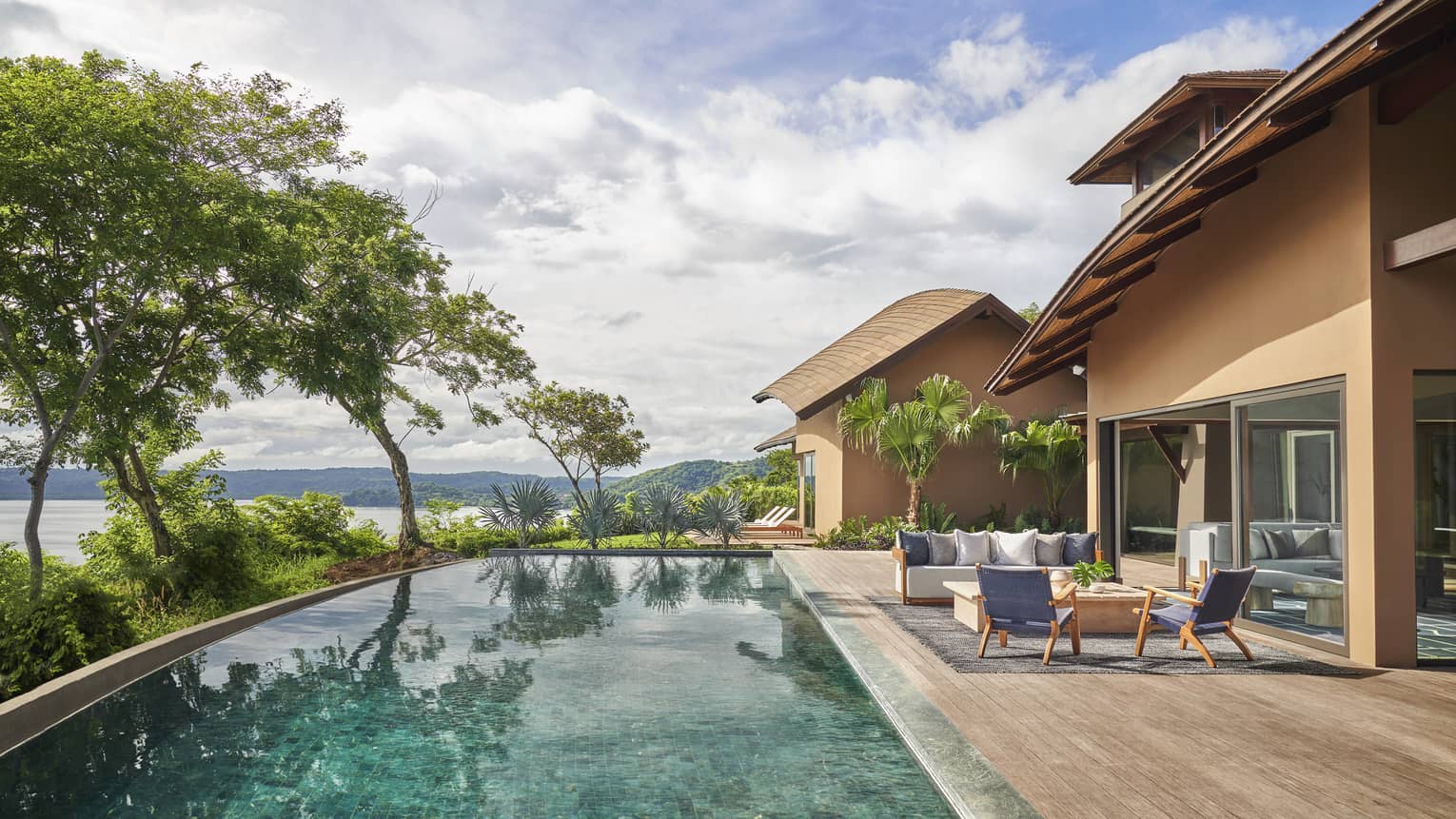 Private villa's pool with lounge furniture and sea views