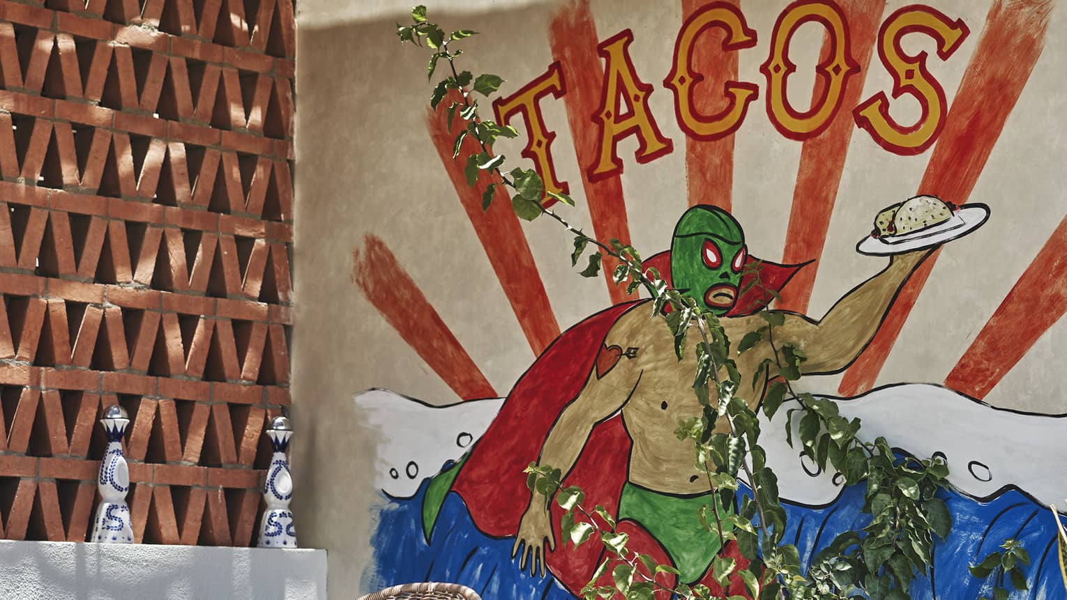 A painting of a green wrestler holding a taco on a plate behind a round chair outside.