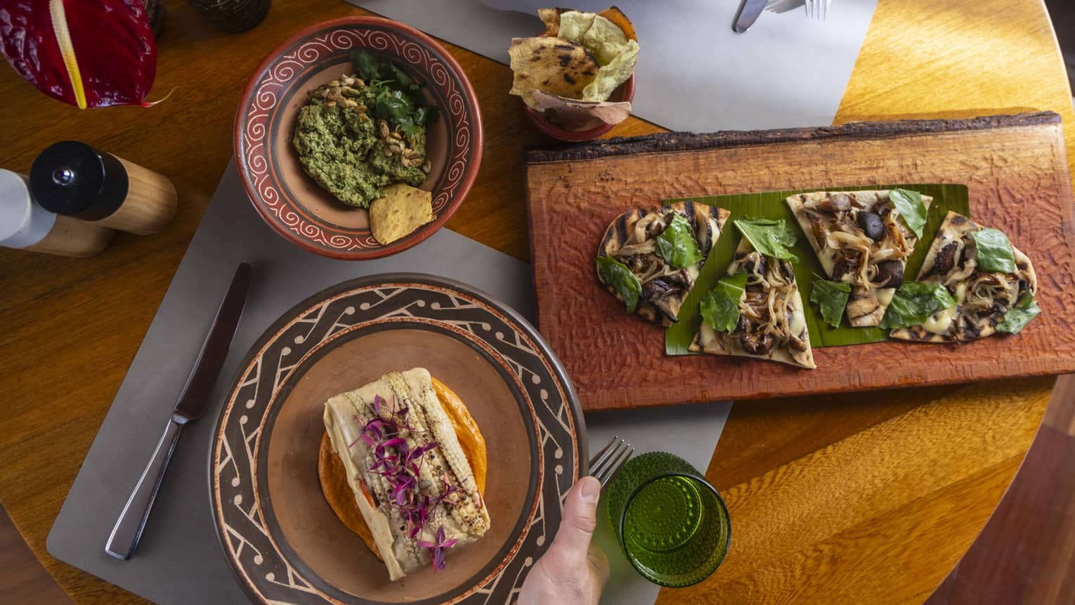 Selection of Latin American dishes served on a round wooden table