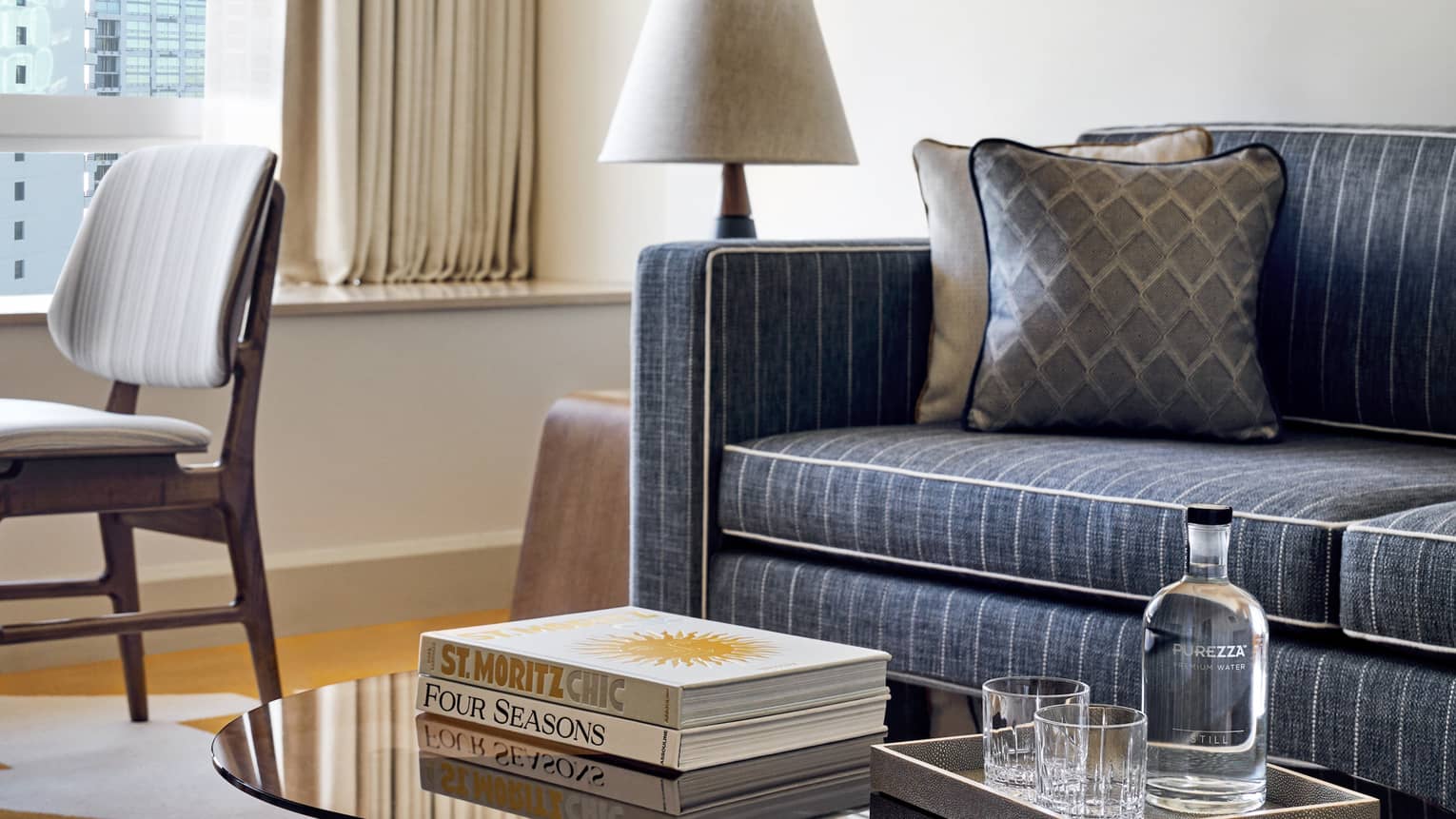 Living room with coffee table, denim pinstripe sofa and chair