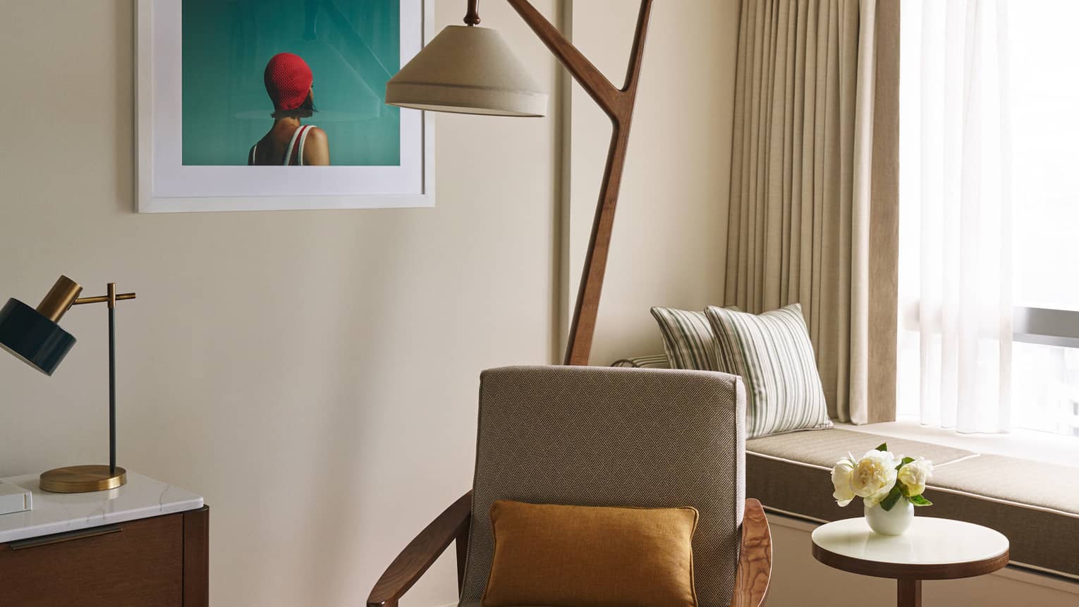 Hotel room corner arm chair and floor lamp, built-in window bench
