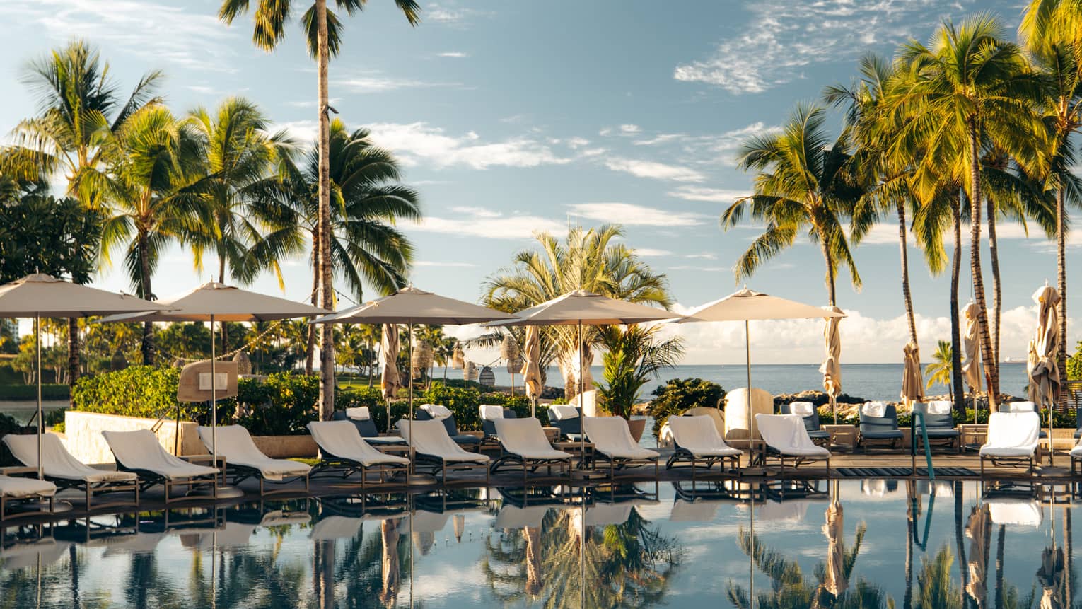 Hawaiian tropical resort pool with beach in the background