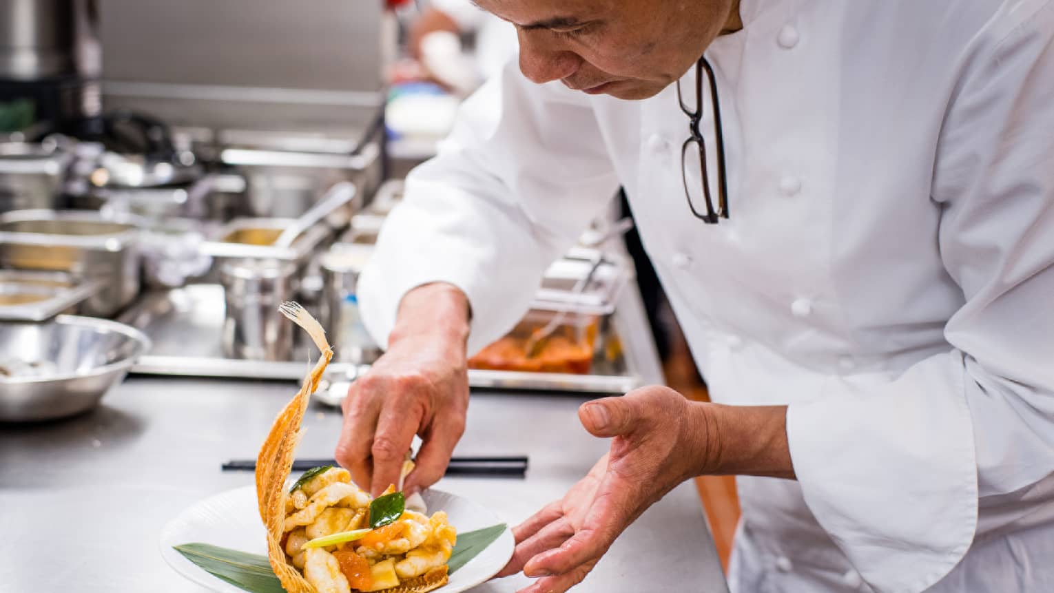 Chef in Mei Ume kitchen preparing a dish