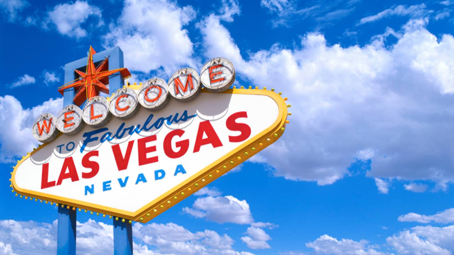 A sign that says "Welcome to Fabulous Las Vegas" with a bright blue sky behind it.