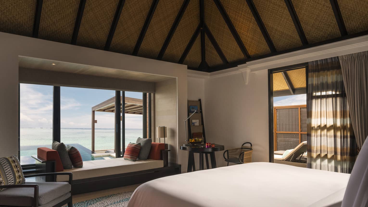 Looking out at the sea view from inside the sunrise water villa with pool