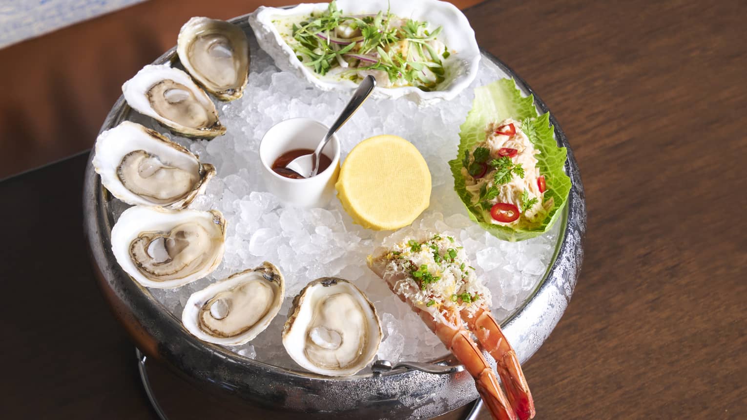 Oysters and lobster tail on ice.