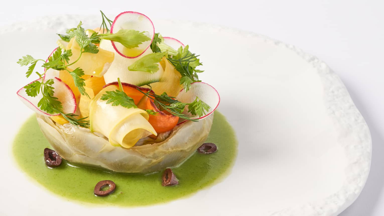  Camus artichokes in vinaigrette of young yegetables on white round plate