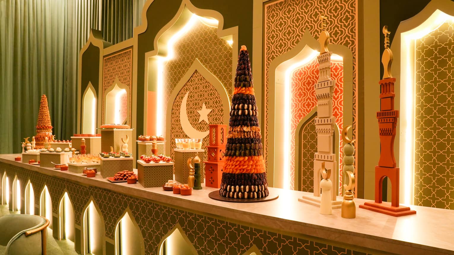 Long counter decorated for Ramadan is filled with desserts