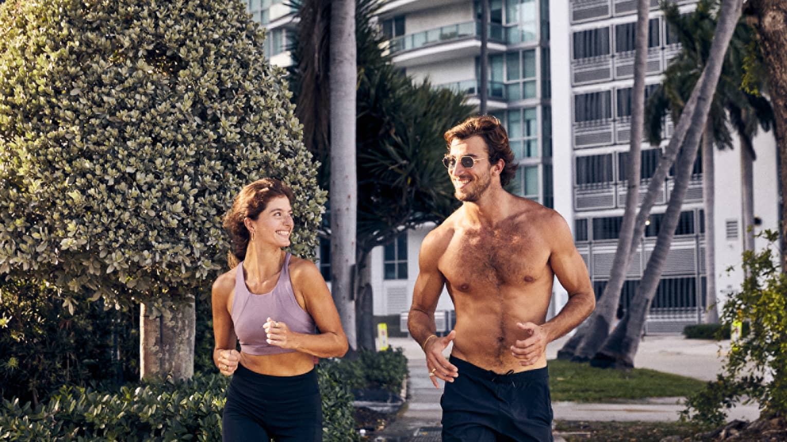 A man and woman running along a path.