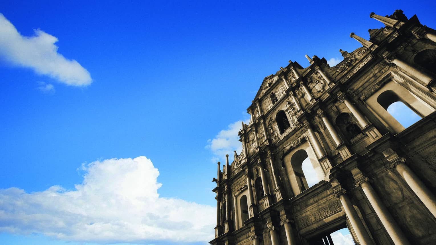 Looking up at St. Paul cathedral ruins, facade against blue sky
