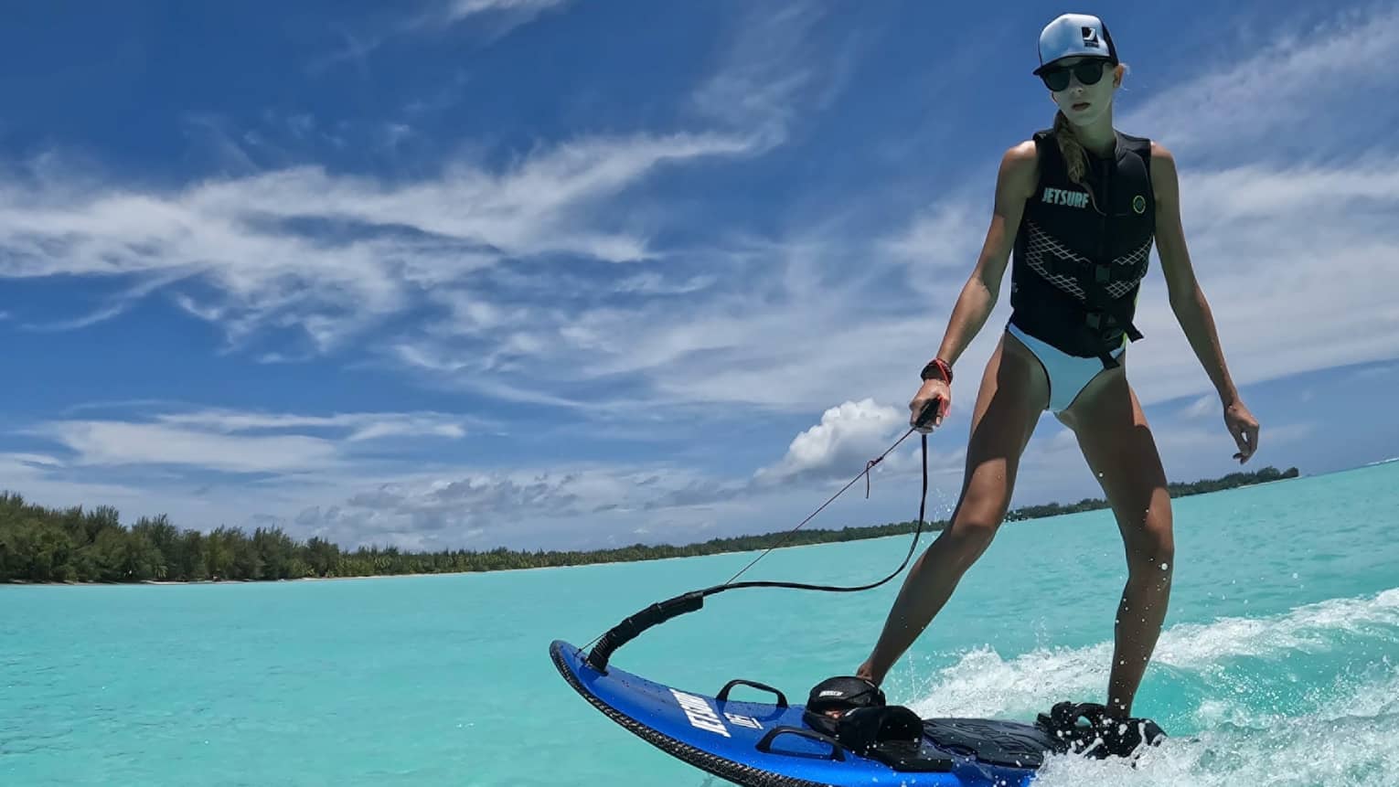 Person rides JETSURF board on turquoise waters