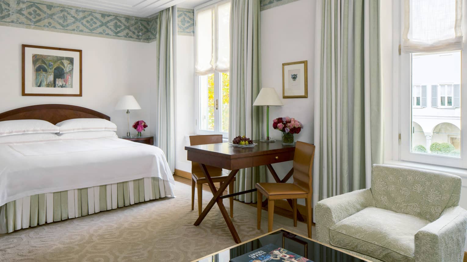 Premier Room Garden View bed, wood desk with chairs, armchair by tall sunny windows