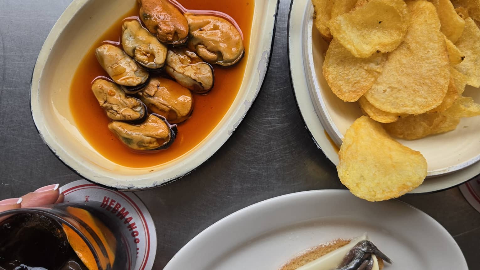 Seafood dish with chips on the side and a drinking glass