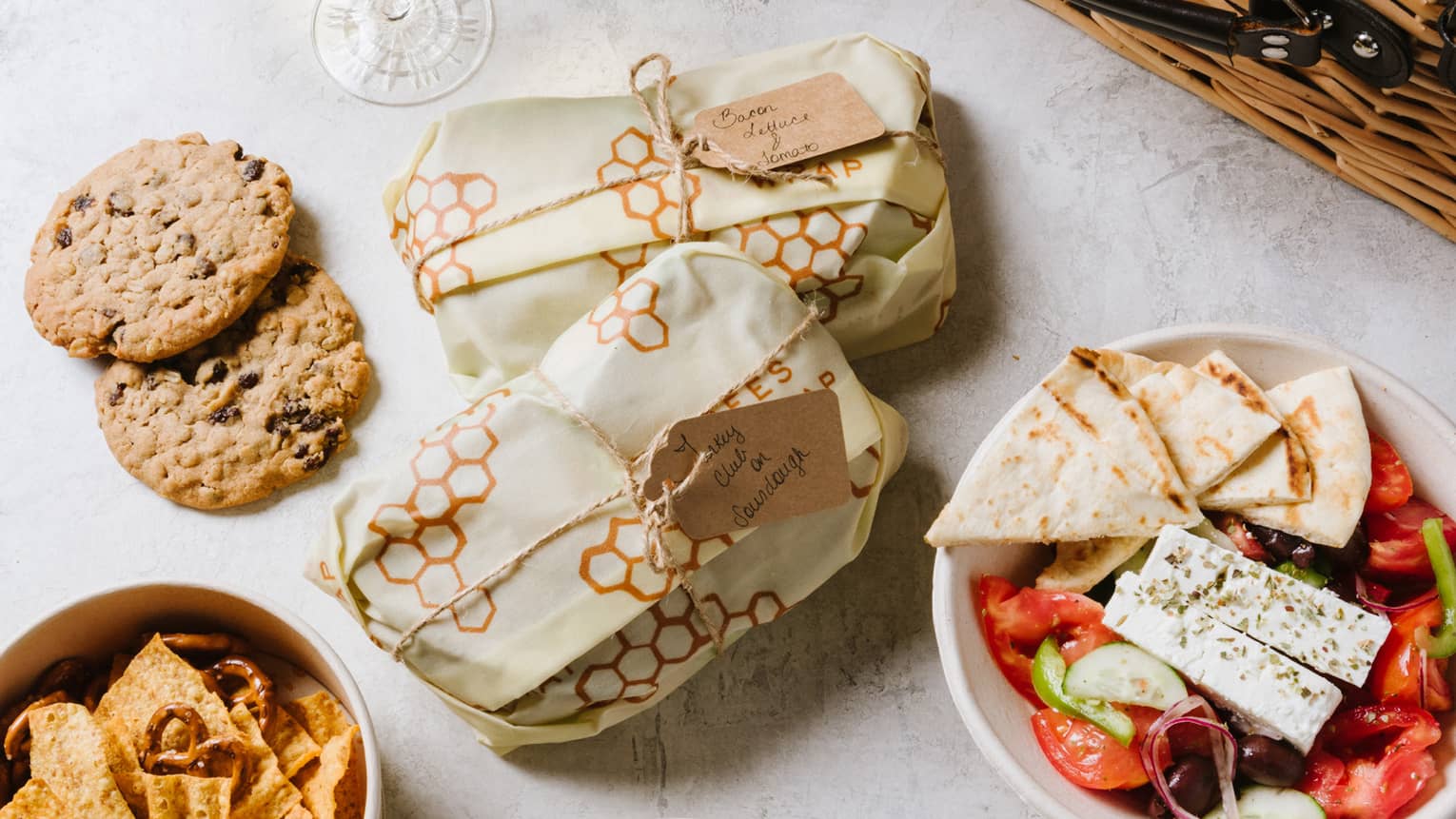 An assortment of food including salad, cookies and bread.
