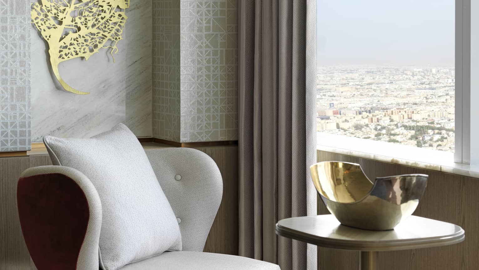 Contemporary arm chair by window with small table