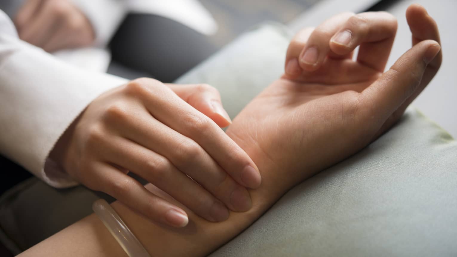 Hand placed on wrist in spa