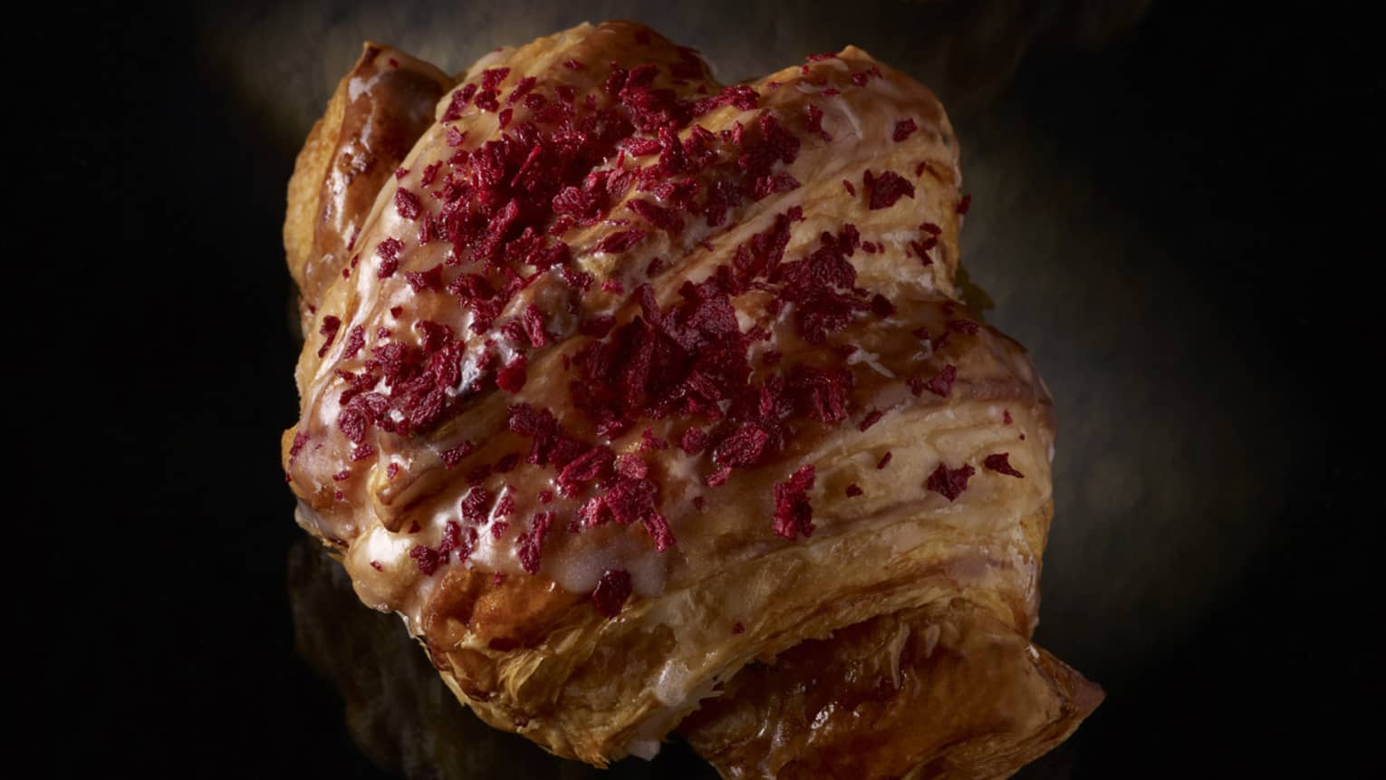 Two croissants dusted with a red spice.