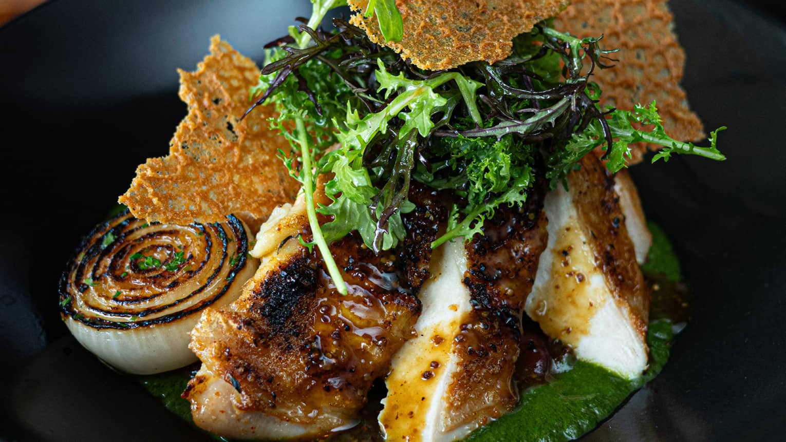 Food with garnish on a black plate