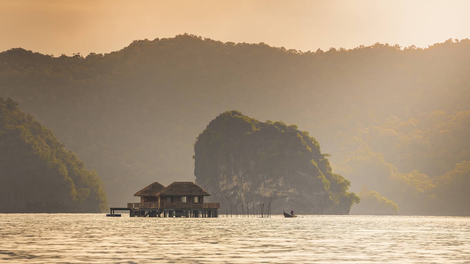 An undisturbed lake with huts on the water