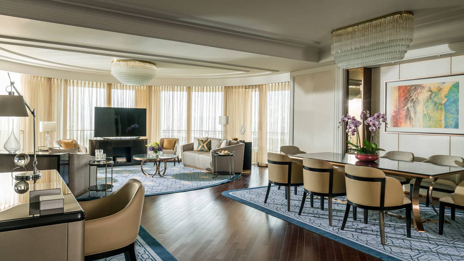 Spacious Presidential Suite desk, dining table in front of spacious living room, TV