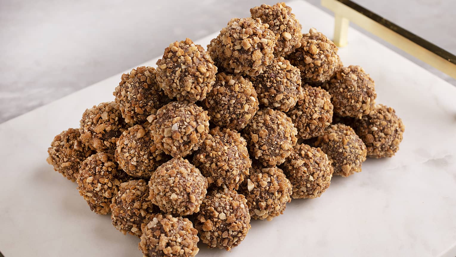 Star anise and hazelnut truffle with a milk chocolate shell, star anise and milk chocolate ganache coated with roasted hazelnuts