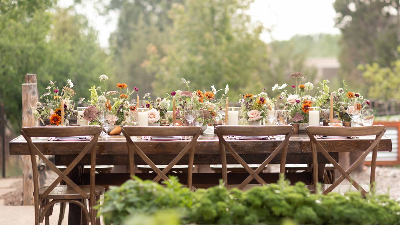 A table outside covered in flowers.