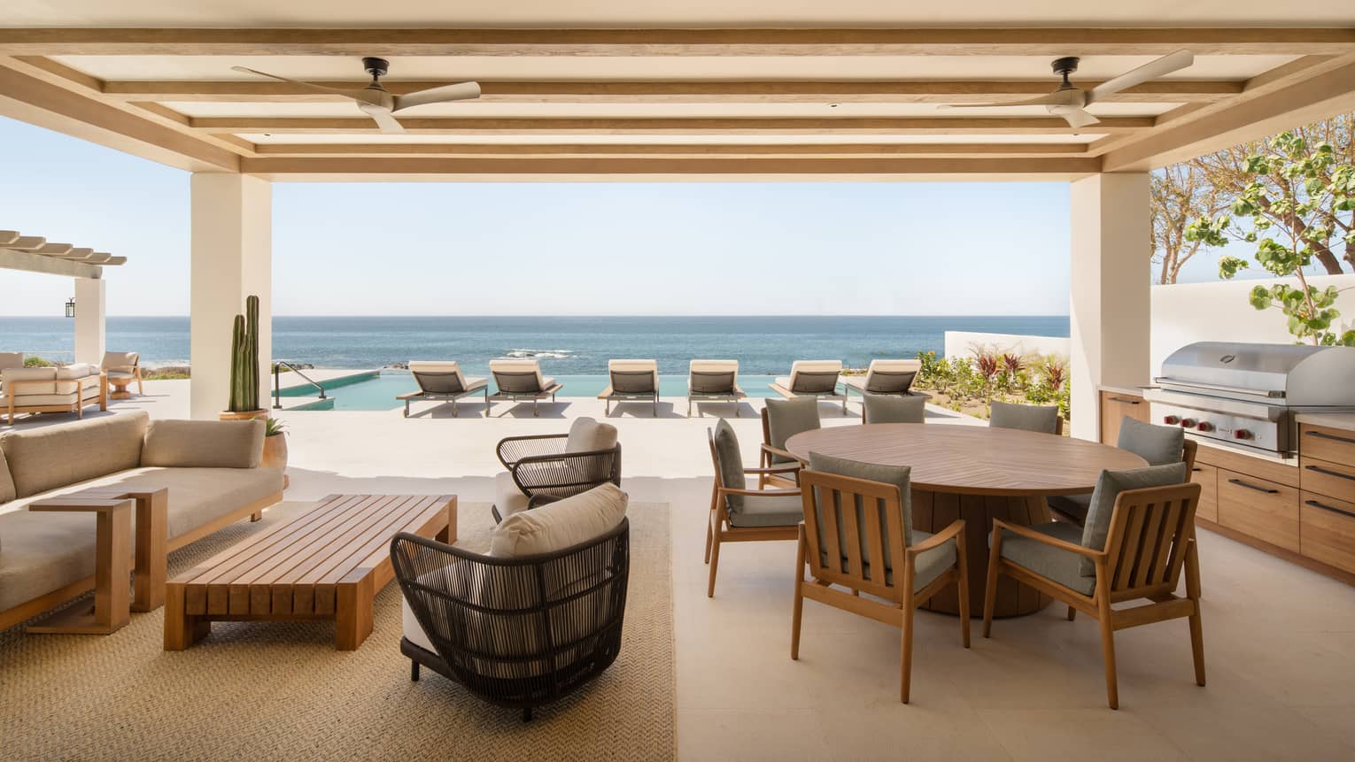Luxury oceanfront suite terrace with dining, lounge and pool furniture, at Four Seasons Resort Cabo San Lucas at Cabo Del Sol
