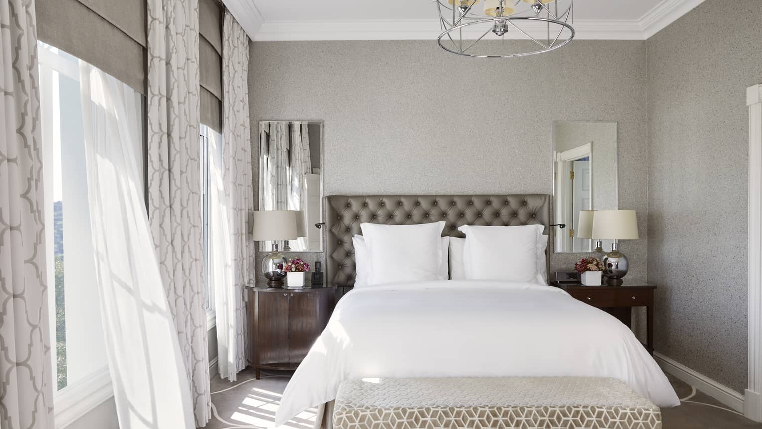 Luxury hotel suite bedroom with modern grey and white interiors at Four Seasons Hotel Johannesburg