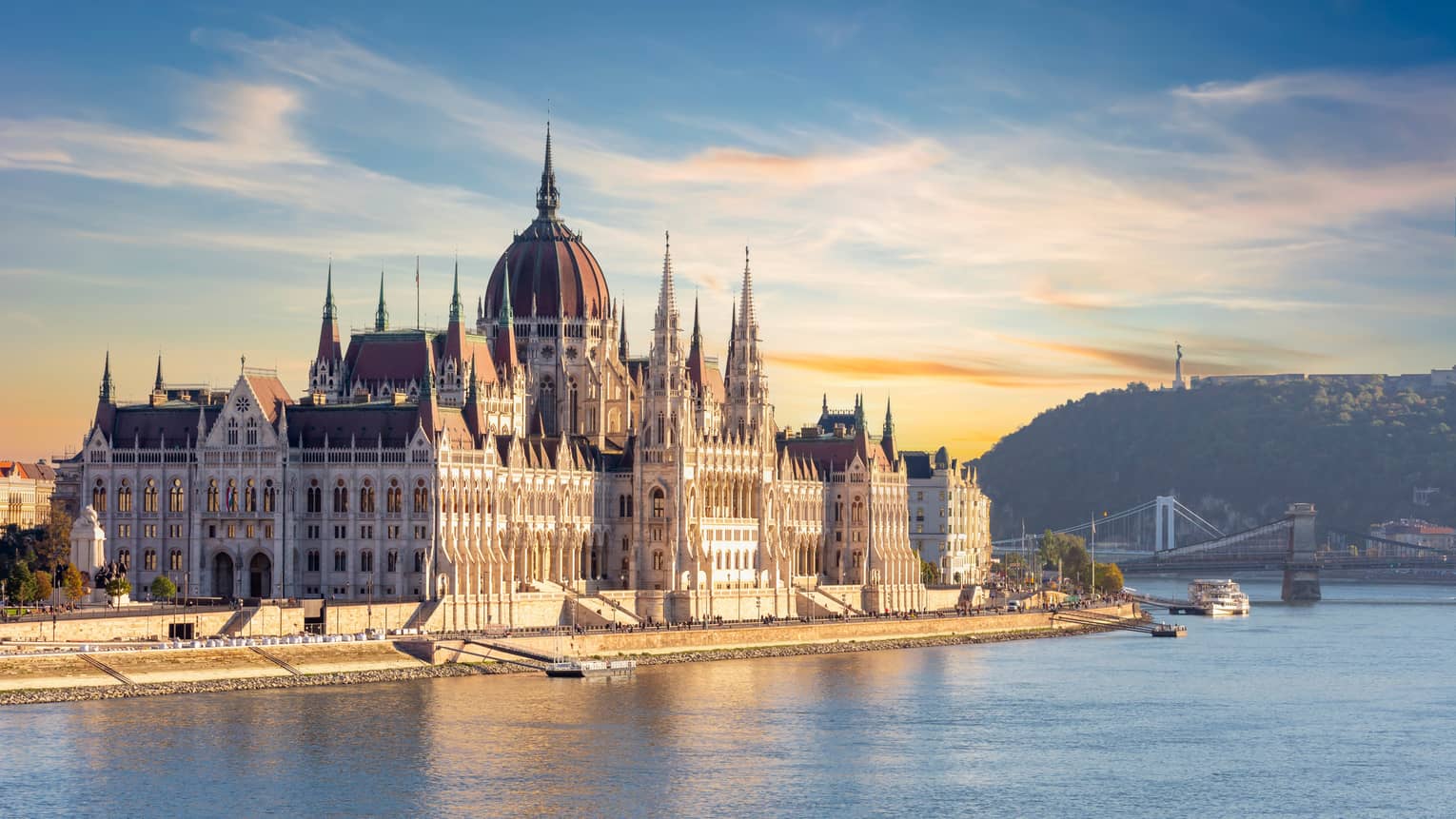A large castle or palace on the edge of water.