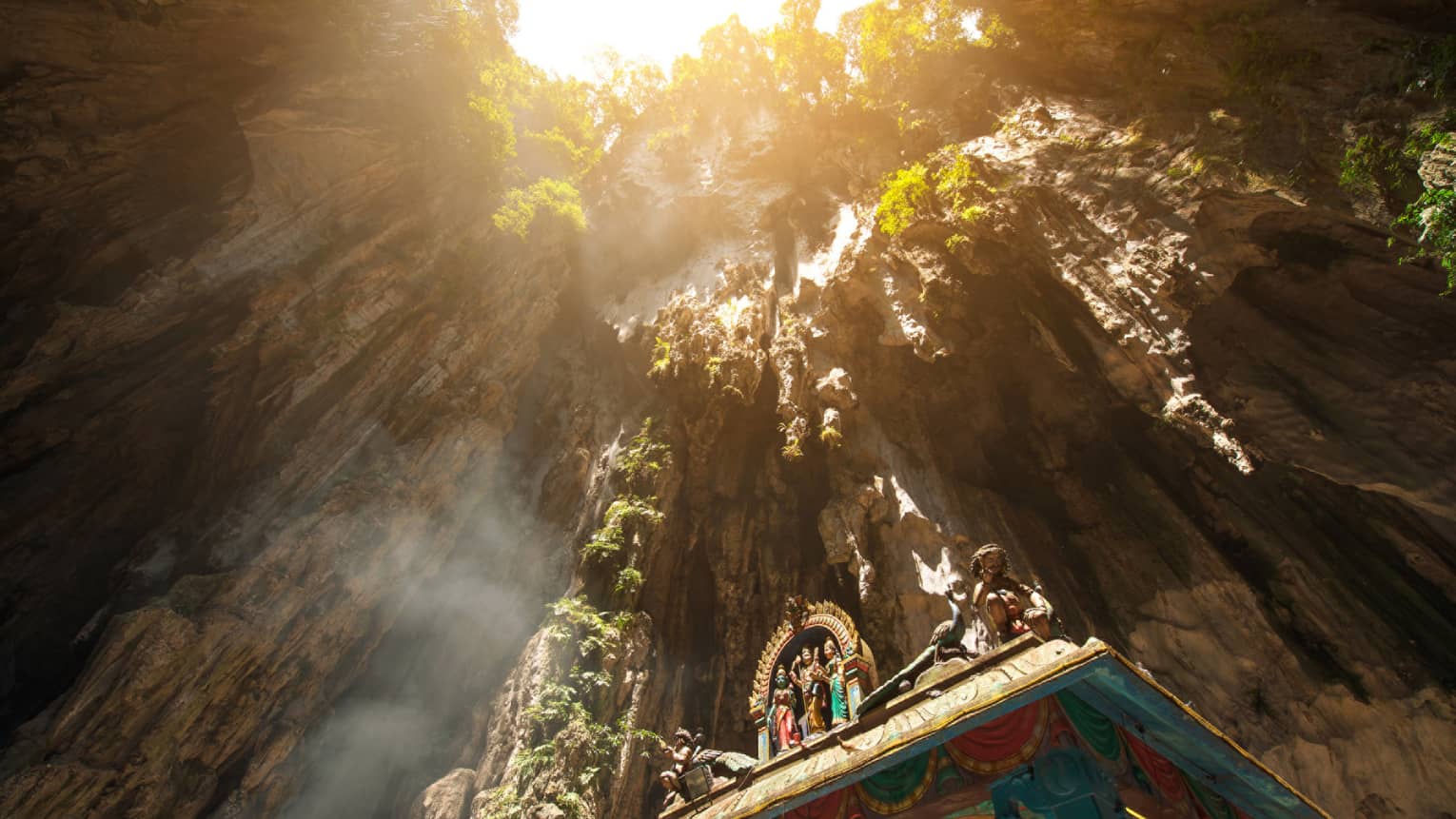 View looking up at rocks through Hindu temple at Batu caves in Malaysia
