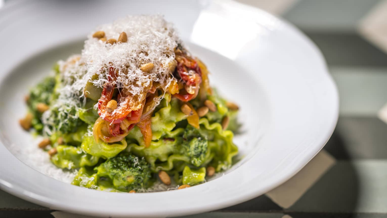 A colourful dish of green and red on a white plate.