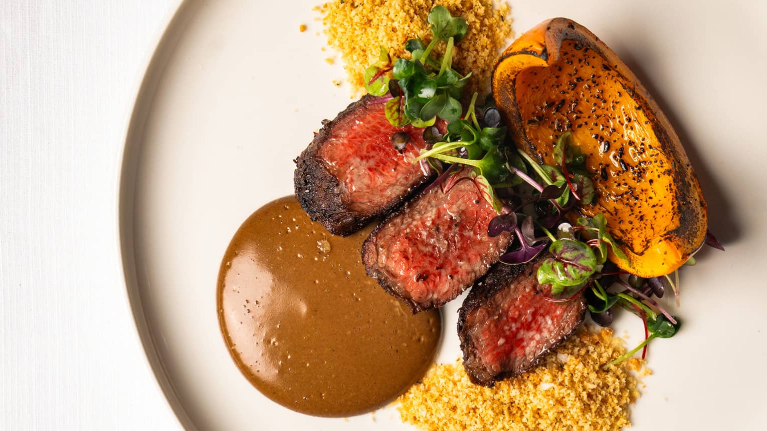 Grilled Picanha served on a round white plate
